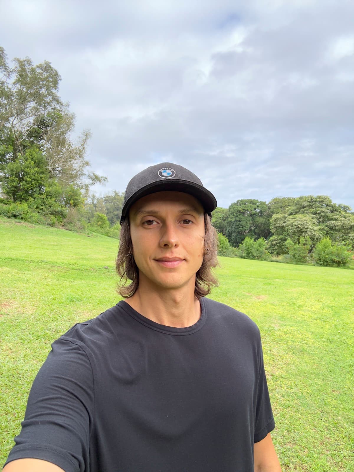 Alex, founder of Fixty and Bimmer Tech Pro — wearing a BMW cap in Hawaii