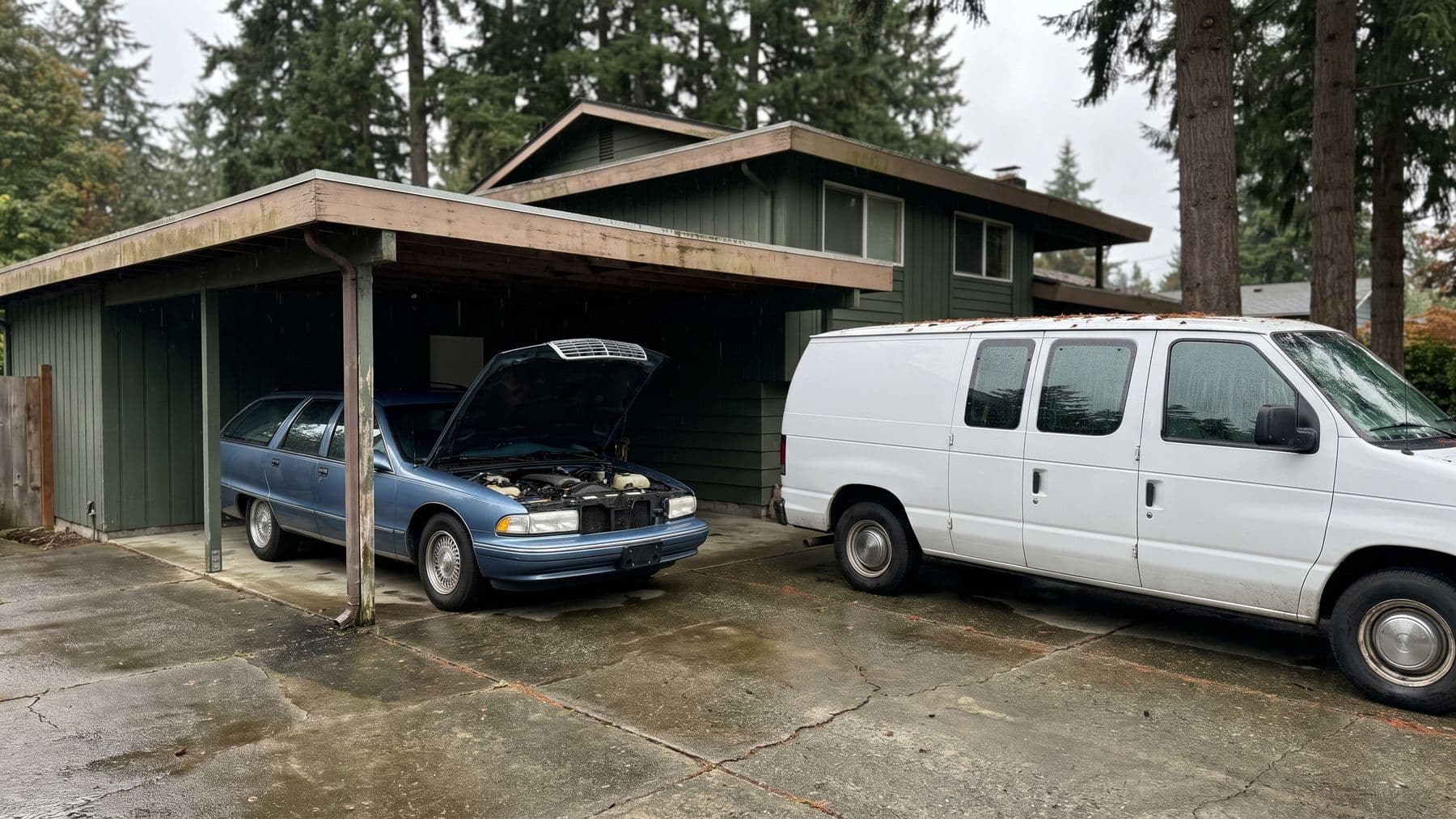 Illustration: a blue station wagon with its hood raised under the carport of a green split-level in Shoreline, Washington, a white van on the wet driveway.